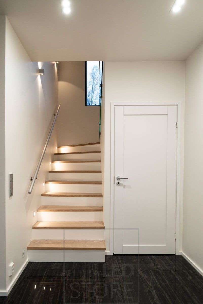 Soft indirect light on the steps of the staircase with recessed wall luminaires. Additional bi-directional wall lights.